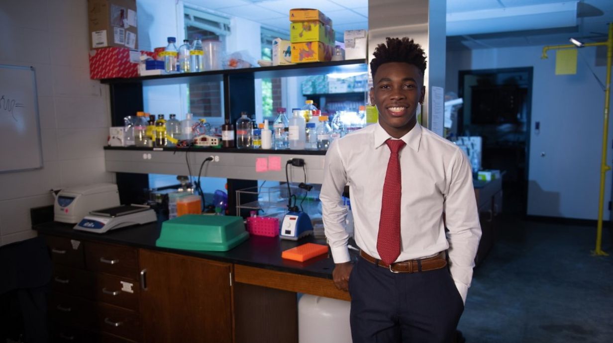 Student poses in a scientific lab.