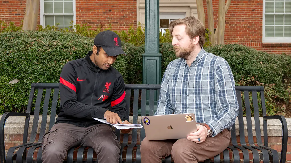 Miles Armaly mentors a grad student outside of Deupree Hall.