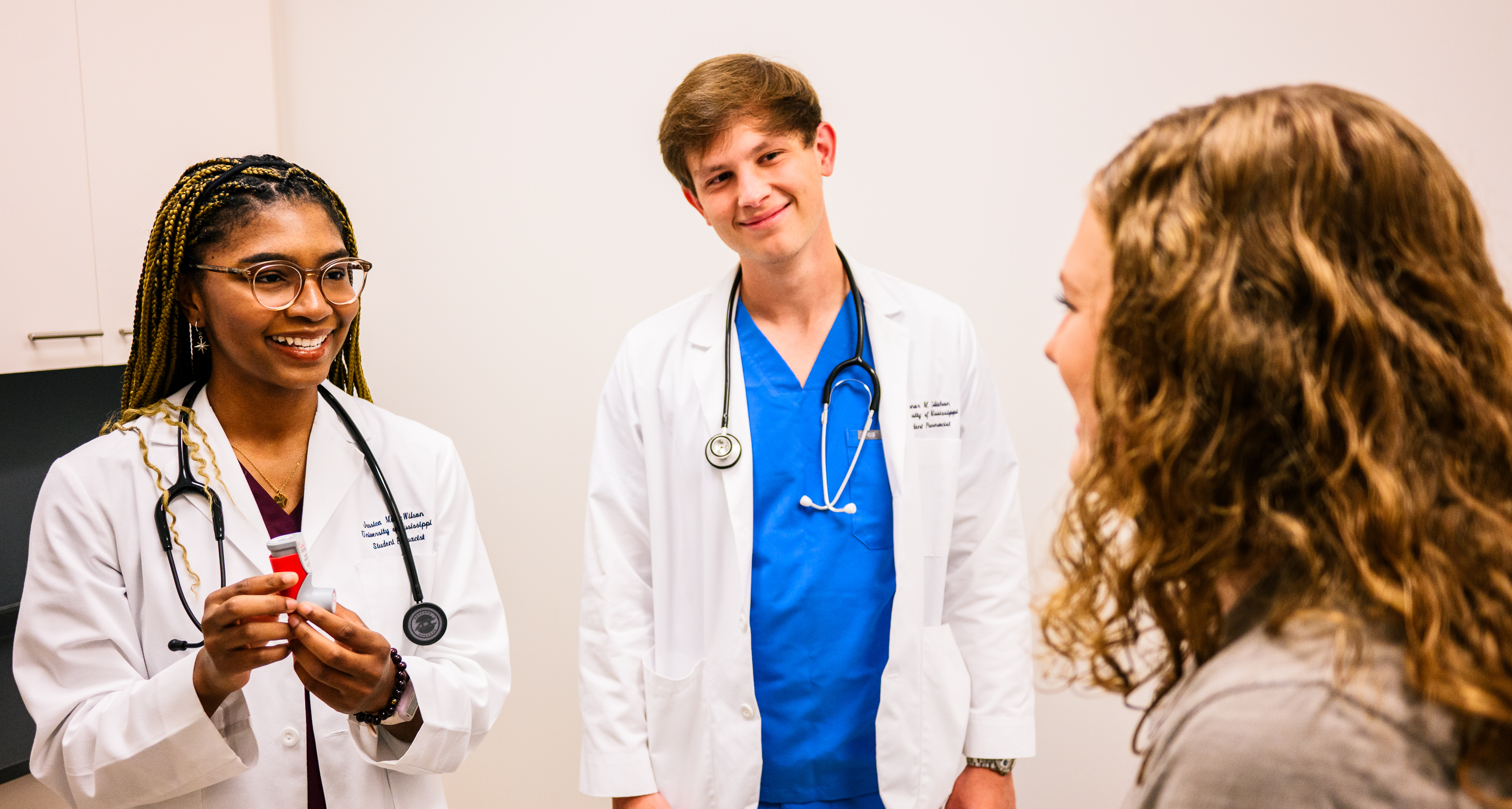A pharmacy student consulting with a patient.
