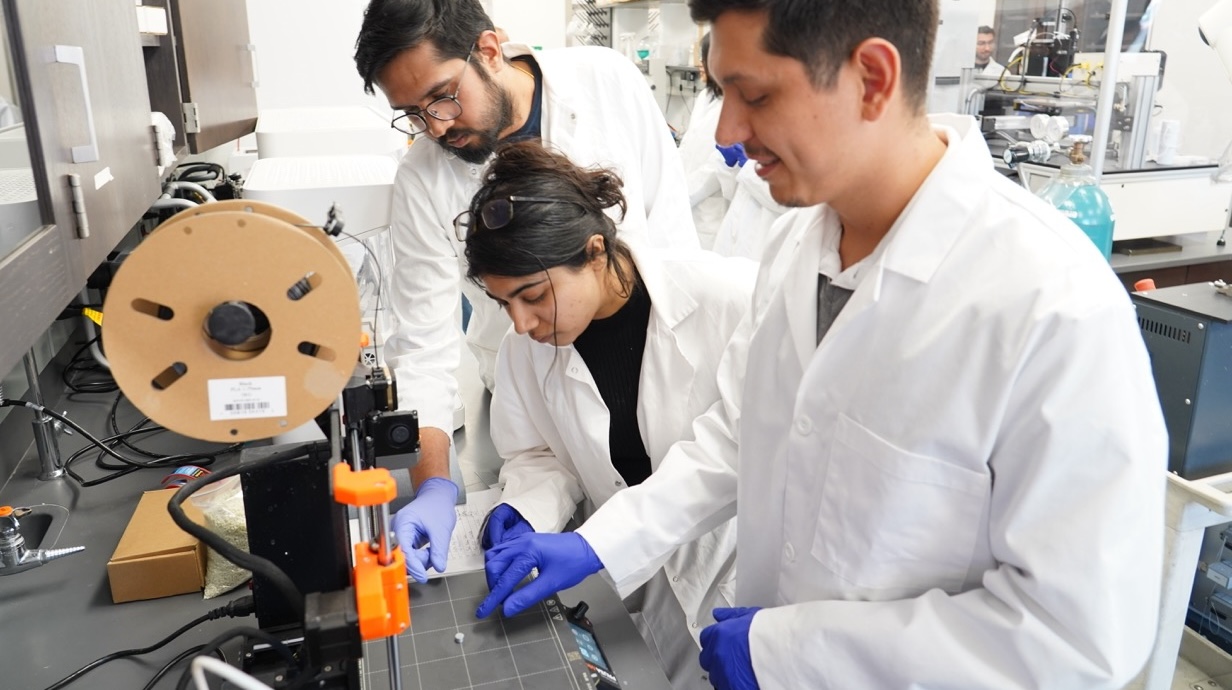 Photo of pharmaceutics researchers working in a lab.