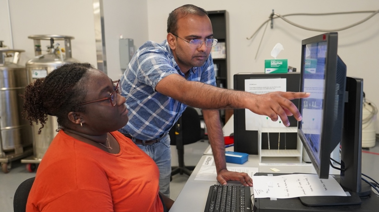 Photo of pharmaceutical sciences researchers studying in a lab.