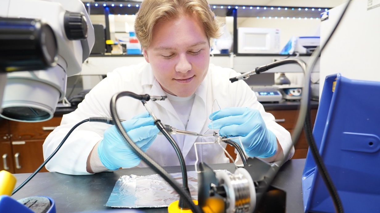 Photo of pharmacology researchers studying in a lab.