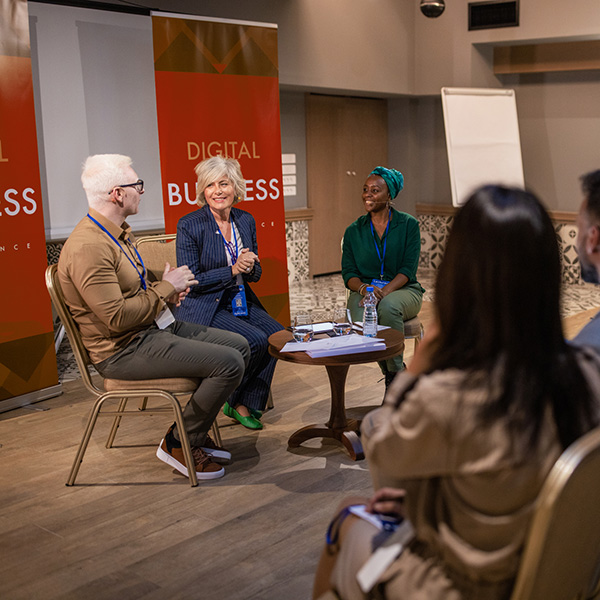 A panel discussion to an audience of students in the School of Business.