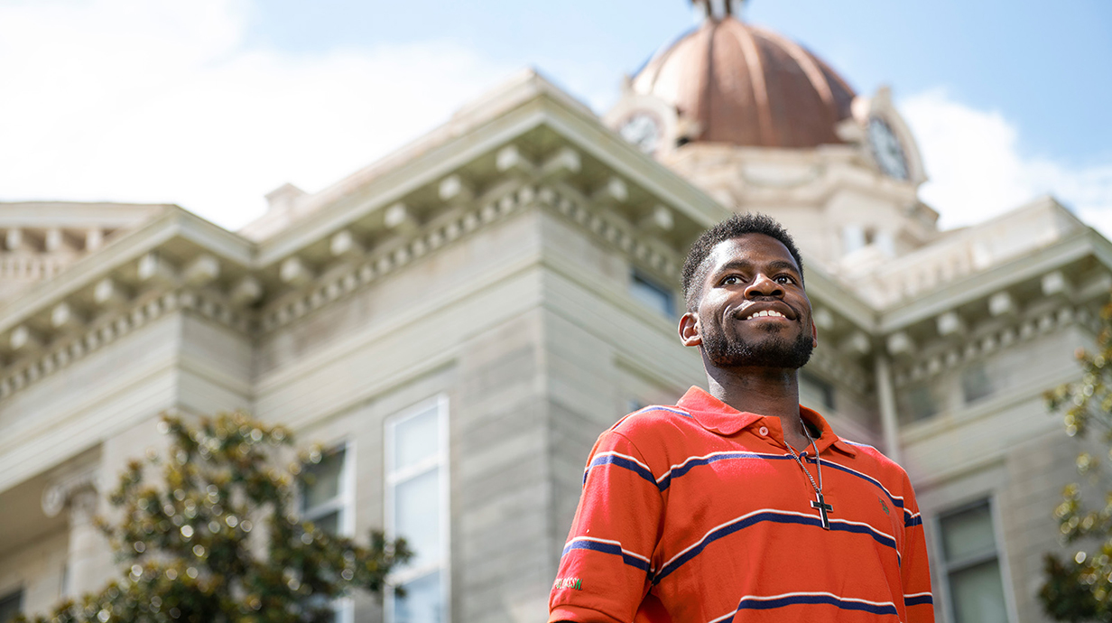 Male student standing in front of court house