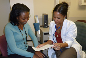 Meagan Brown (right) works closely with a patient.