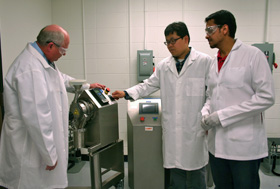 Michael A. Repka (left) with students in the tableting lab