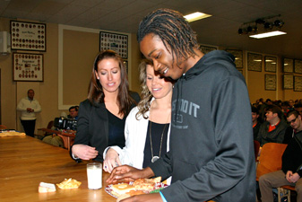 Pharmacy students Emily Carrell and Ashley Hale teach Dione Golden (right) about healthy eating. 