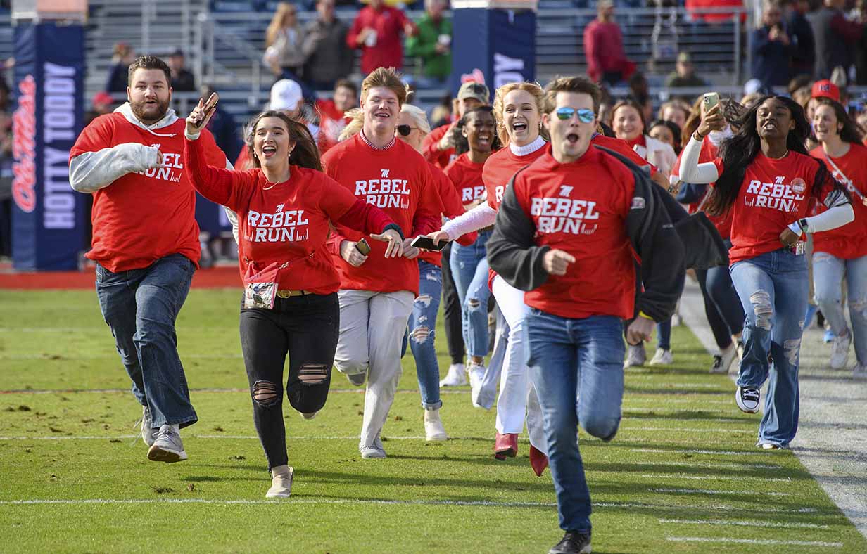 Ole Miss freshmen students sprint across the football field in Vaught Hemingway stadium as part of the annual Rebel Run.
