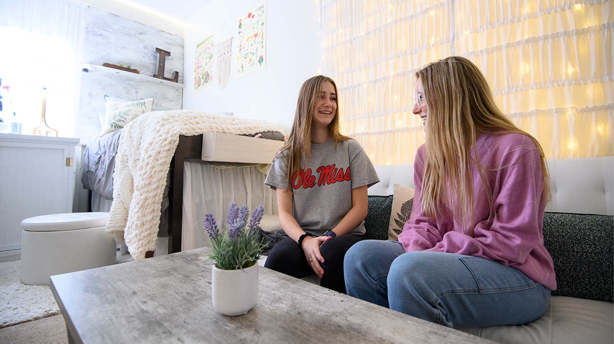 Two new Ole Miss students relax in their new dorm room.