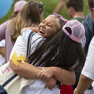 Two members hug on Sorority Row during Bid Day for CPH Recruitment