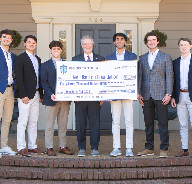 Chancellor Boyce at a check presentation at Phi Delta Theta for their philanthropy.