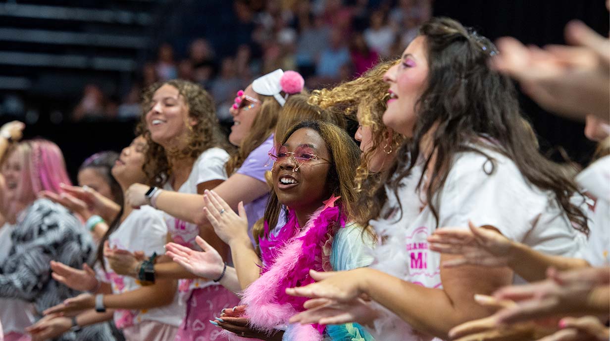 Sorority members perform on stage during Bid Day activities at the Pavilion.