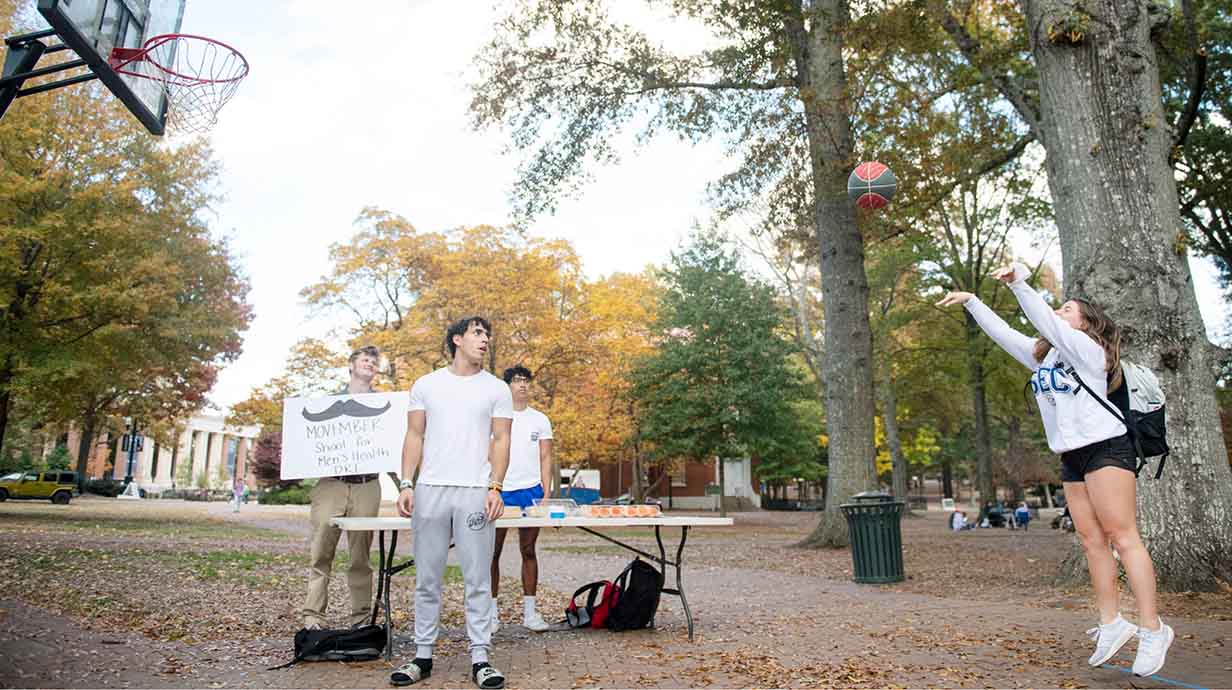 Members of Delta Kappa Epsilon hold a basketball shooting challenge in the Circle to raise money for charity.
