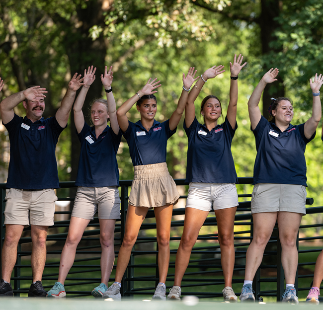 Ole Miss student orientation leaders perform on the Grove stage for a group of new incoming freshmen and their parents.