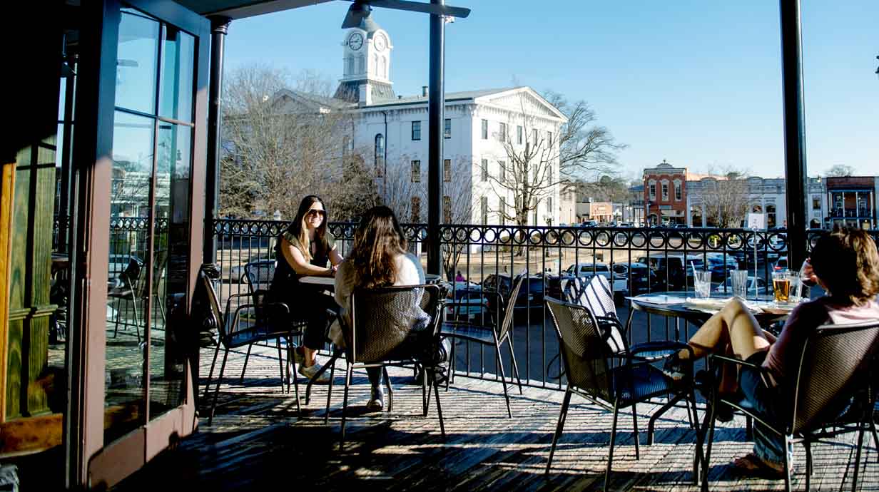  Friends enjoy a Spring afternoon relaxing on a balcony overlooking the Square.