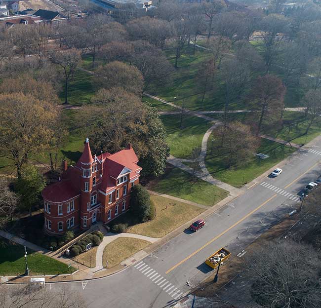An aerial shot of Ventress Hall and and empty Grove early on a spring morning.