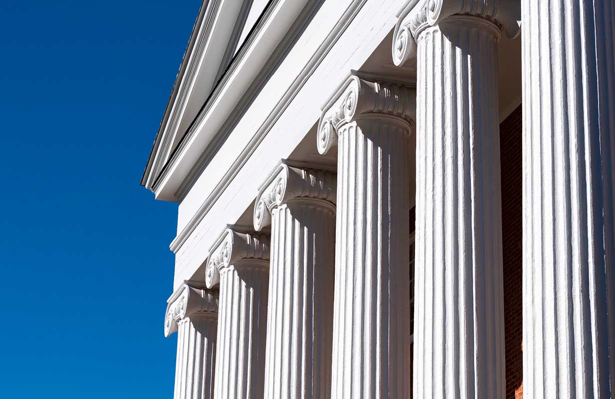 The Lyceum columns are shown up close with the blue sky in the background.