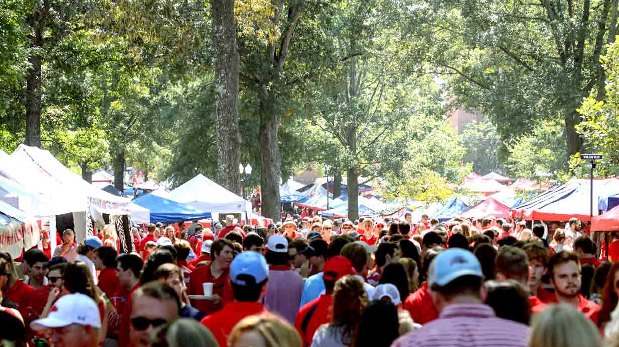 Ole Miss fans crowd the sidewalks in the Grove before a Saturday home football game.