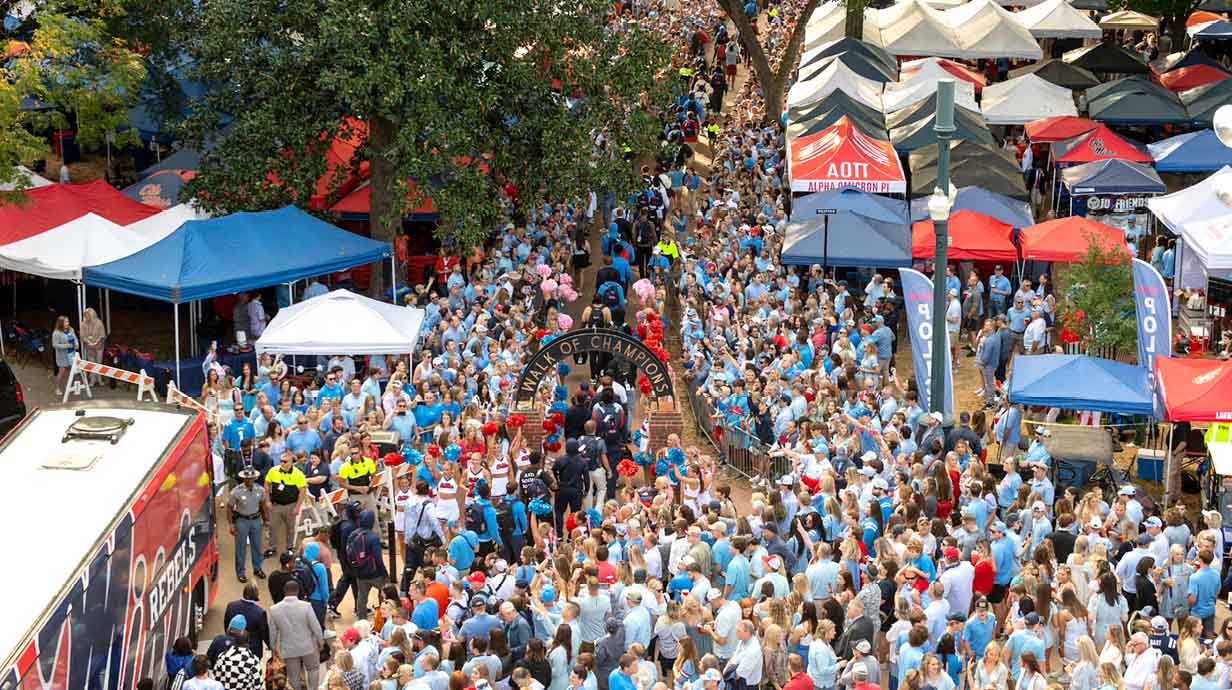 Crowds surround the Walk of Champions as the football players proceed through the Grove to Vaught Hemingway Stadium on a game day Saturday.